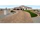 Elegant two-story home with a three-car garage and landscaped front yard at 25232 S Pyrenees Ct, Queen Creek, AZ 85142