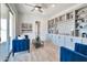 Bright Gathering room featuring built-in shelving and blue velvet sofas at 25232 S Pyrenees Ct, Queen Creek, AZ 85142