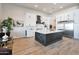 Modern kitchen with a large island, white cabinets, and stainless steel appliances at 25232 S Pyrenees Ct, Queen Creek, AZ 85142