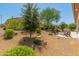 Landscaped backyard with fire pit and seating area at 26647 W Covey Ln, Buckeye, AZ 85396