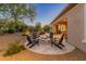 Backyard patio with fire pit and seating area at 26647 W Covey Ln, Buckeye, AZ 85396