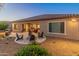 Backyard patio with fire pit and seating area at 26647 W Covey Ln, Buckeye, AZ 85396