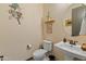 Clean bathroom with pedestal sink, toilet, and decorative wall art at 26647 W Covey Ln, Buckeye, AZ 85396