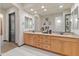 Elegant bathroom with double vanity, granite countertop, and large mirror at 26647 W Covey Ln, Buckeye, AZ 85396