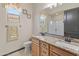 Bathroom with double vanity, granite countertop, and a large mirror at 26647 W Covey Ln, Buckeye, AZ 85396