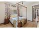 Bright bedroom with canopy bed, hardwood floors, and stylish decor at 26647 W Covey Ln, Buckeye, AZ 85396