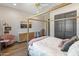 Bedroom featuring a gold canopy bed, wood floors, and desk at 26647 W Covey Ln, Buckeye, AZ 85396