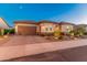 Single-story home with a brick driveway and desert landscaping at 26647 W Covey Ln, Buckeye, AZ 85396