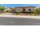 Single story home with desert landscaping and a two-car garage at 26647 W Covey Ln, Buckeye, AZ 85396