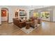 Cozy living room features leather sofas and built-in shelving at 26647 W Covey Ln, Buckeye, AZ 85396