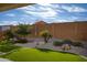 Landscaped backyard with artificial turf, gravel, and drought-tolerant plants at 26861 W Adam Ave, Buckeye, AZ 85396