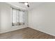 Simple bedroom with wood-look floors and a window at 26861 W Adam Ave, Buckeye, AZ 85396