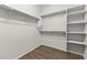 Large walk-in closet with hanging rods and shelves at 26861 W Adam Ave, Buckeye, AZ 85396