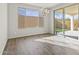 Bright dining room featuring hardwood floors and sliding glass doors to backyard at 26861 W Adam Ave, Buckeye, AZ 85396