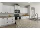 Modern kitchen with white cabinets, granite countertops and stainless steel appliances at 26861 W Adam Ave, Buckeye, AZ 85396