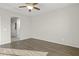 Spacious living room with hardwood floors and access to hallway at 26861 W Adam Ave, Buckeye, AZ 85396