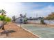 Backyard view showcasing a paddleball court and desert landscaping at 280 E Morelos St, Chandler, AZ 85225