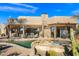 Inviting pool and spa with a stone patio and covered seating area at 3071 Ironwood Rd, Carefree, AZ 85377