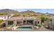 Beautiful backyard featuring a pool, spa, and outdoor living area with a spiral staircase at 3254 N Ladera Cir, Mesa, AZ 85207