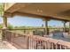 Covered balcony featuring an outdoor dining set with views of the surrounding desert landscape at 3254 N Ladera Cir, Mesa, AZ 85207