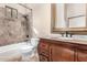 Bathroom featuring a classic vanity, decorative mirror, and tiled shower-tub combination at 3254 N Ladera Cir, Mesa, AZ 85207