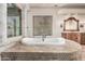 Luxury bathroom with a central tub, tiled platform, and dual sinks at 3254 N Ladera Cir, Mesa, AZ 85207