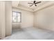 Bright bedroom with carpet, a ceiling fan, and a large window with coverings providing ample natural light at 3254 N Ladera Cir, Mesa, AZ 85207