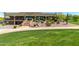 Community clubhouse featuring a balcony, lush landscaping, and a large grass area for gatherings at 3254 N Ladera Cir, Mesa, AZ 85207