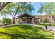 Clubhouse exterior showcasing stone accents, covered entrances, professional landscaping, and a well-manicured lawn at 3254 N Ladera Cir, Mesa, AZ 85207