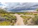 Scenic view of a residential community with lush desert vegetation and distant mountain vistas at 3254 N Ladera Cir, Mesa, AZ 85207