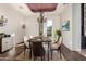 Elegant dining room with modern chandelier, wainscoting, and light-filled windows, perfect for entertaining at 3254 N Ladera Cir, Mesa, AZ 85207