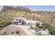 Expansive desert home featuring large windows, a circular driveway, and lush desert landscaping at 3254 N Ladera Cir, Mesa, AZ 85207