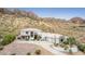 Gorgeous desert home with a circular driveway, lush landscaping, and stunning mountain views at 3254 N Ladera Cir, Mesa, AZ 85207