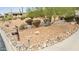 Landscaped front yard featuring desert vegetation and decorative rocks with the house number clearly visible at 3254 N Ladera Cir, Mesa, AZ 85207