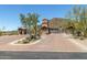 Gated community entrance with decorative stone accents and lush desert landscaping at 3254 N Ladera Cir, Mesa, AZ 85207