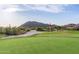 Scenic golf course view with a red flag, lush green grass, and mountain views at 3254 N Ladera Cir, Mesa, AZ 85207