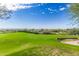 Expansive view of the community golf course with lush green fairways and the homes in the distance at 3254 N Ladera Cir, Mesa, AZ 85207