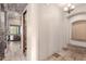 Arched hallway leading to the kitchen with stone tile at 3254 N Ladera Cir, Mesa, AZ 85207