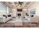 Stylish living room with coffered ceiling, fireplace, and hardwood floors, perfect for entertaining guests at 3254 N Ladera Cir, Mesa, AZ 85207