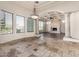 Bright living room with large windows, stone flooring, and decorative columns at 3254 N Ladera Cir, Mesa, AZ 85207