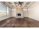 Spacious living room boasts a coffered ceiling, fireplace, and wood flooring at 3254 N Ladera Cir, Mesa, AZ 85207