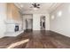 Spacious living room featuring wood floors, custom ceilings, and decorative fireplace at 3254 N Ladera Cir, Mesa, AZ 85207