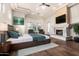 Serene main bedroom with a stone fireplace, soft lighting, and backyard views for ultimate relaxation at 3254 N Ladera Cir, Mesa, AZ 85207