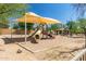 Community playground featuring a slide, climbing structure, and shaded seating area at 3254 N Ladera Cir, Mesa, AZ 85207