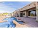 Resort-style backyard pool area with a spiral staircase, built-in grill and covered patio at 3254 N Ladera Cir, Mesa, AZ 85207