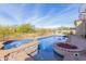 Inviting backyard pool and spa with a fire pit and desert landscape at 3254 N Ladera Cir, Mesa, AZ 85207