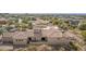 Aerial of home's rear exterior showing multiple windows, roof, and desert landscape at 3254 N Ladera Cir, Mesa, AZ 85207