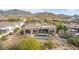 View of home's rear exterior with refreshing pool and hot tub and desert landscape at 3254 N Ladera Cir, Mesa, AZ 85207