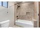 Stone-tiled shower with built-in seat, shower niche, and a sleek shower head in the bathroom at 3254 N Ladera Cir, Mesa, AZ 85207