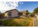 Spacious backyard with a pool, grassy area and stone accents at 3404 E Los Altos Rd, Gilbert, AZ 85297